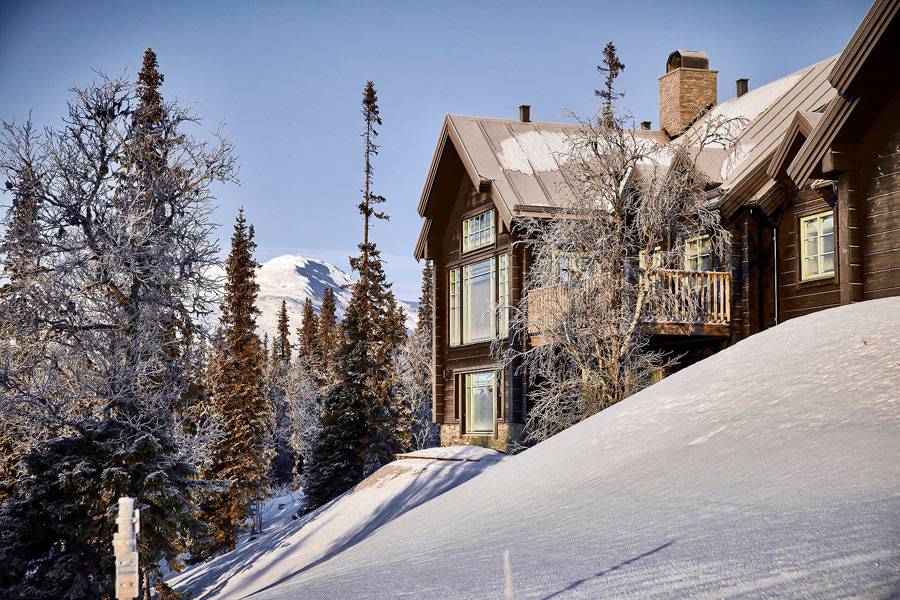 большой деревянный дом-шале в заснеженных горах